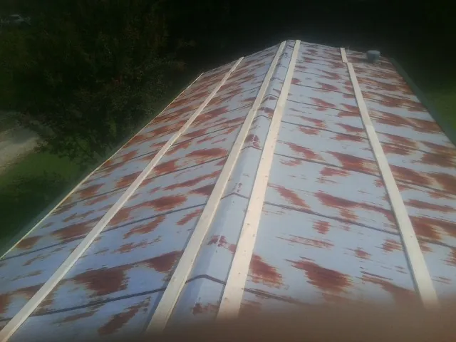 Rusted metal roof panels with new wood purlins before replacement — Storm Damage Roof Repair in Nashville by Roofing Brothers