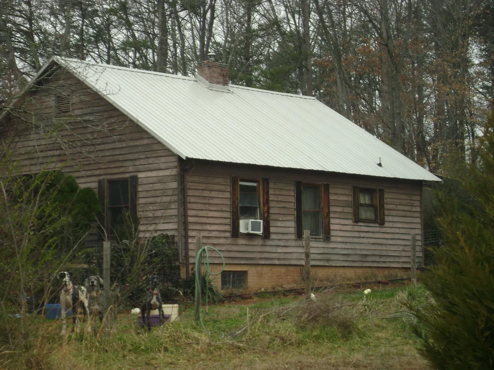 White metal roof on an old wood sided farmhouse, from a Metal Roof Installation job in Nashville
